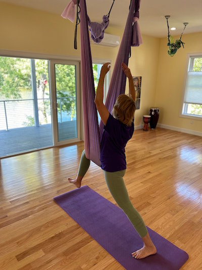 student practicing aerial yoga  at Cheemah studio